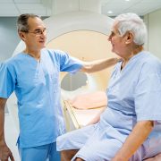 Mature radiologist talking to senior patient