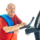 Healthy senior man in GYM leaning on spinning bicycle