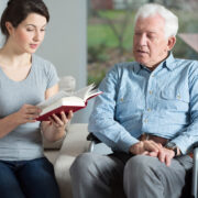 caregiver reading to senior living at home