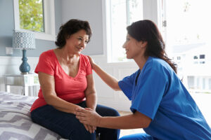 caregiver comforting senior with behaviors of Alzheimer's