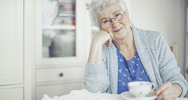 senior woman smiling with a teacup