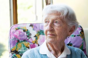 senior-woman-looking-out-window