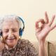 Senior woman enjoying music through headphones
