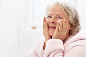 mature woman holding face