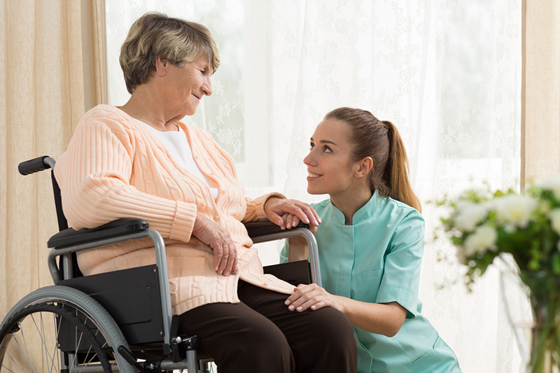 caregiver comforting senior lady