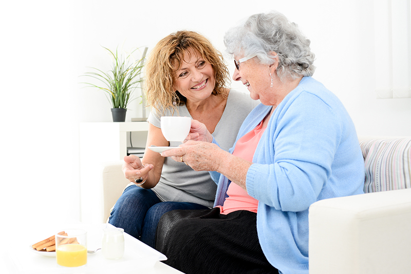 adult daughter talking to senior mother about home care