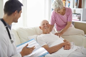 Shot of a handsome male doctor talking to a senior man in hospital