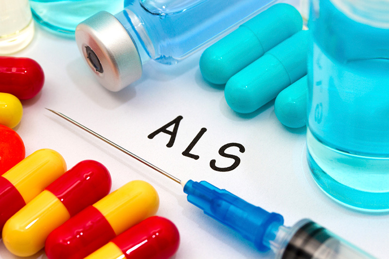 Medications and a syringe, suggesting treatment options for each stage of Lou Gehrig’s disease