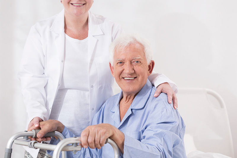 Woman with her arm on a man’s shoulder, helping him make life better with ALS